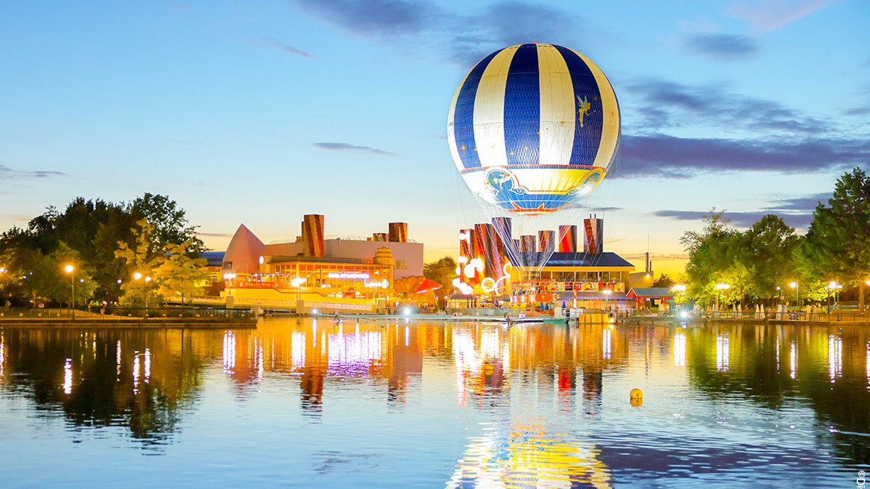 PanoraMagique hot air balloon floating over Disney Village, offering aerial views of Marne-la-Vallée, France.