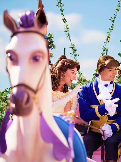 Belle and prince on a floral float during Disneyland Paris parade.